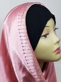 Pink satin hijab scarf with delicate lace trim and rhinestone detailing along the edge, elegant modest fashion headscarf with smooth satin fabric drape designed for everyday wear, formal events, and stylish hijab outfits.