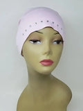 Light pink undercap hijab worn on mannequin, snug stretch cap with small decorative edge details, modest inner hijab cap for secure fit under scarves, soft comfortable fabric for daily wear, side and front view