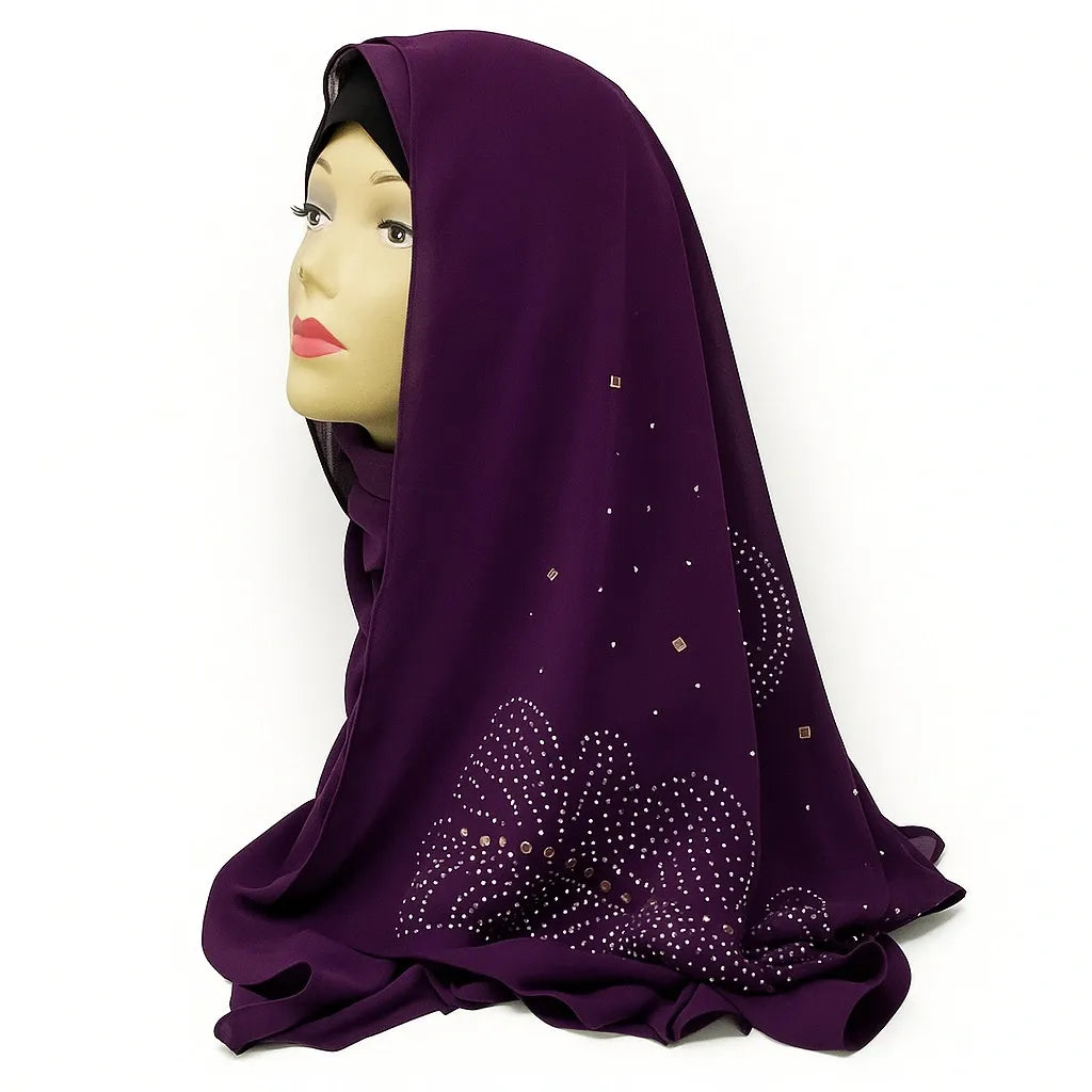 Plum purple chiffon hijab with rhinestone embellishments draped on mannequin, elegant modest fashion scarf for Muslim women, lightweight breathable chiffon headscarf perfect for Eid, weddings, and special occasions.
