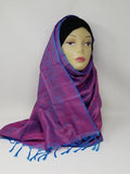Purple and blue patterned hijab scarf with fringe edges, draped on mannequin, lightweight modest wrap, soft textured fabric, full coverage stylish headscarf for everyday wear
