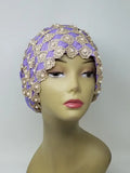 Purple embellished turban headwrap on mannequin, modest headwear with pearl and bead details, soft textured design with snug comfortable fit, elegant style for special occasions, front and side view