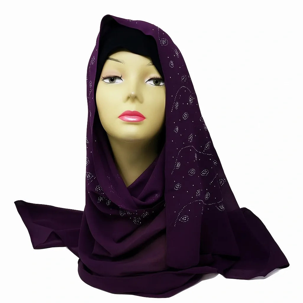 Deep purple chiffon hijab with rhinestone embellishments displayed on mannequin, elegant modest fashion headscarf for women, lightweight breathable chiffon scarf for everyday wear, formal events, weddings, and special occasions.