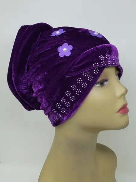 Purple velvet hijab bun cap with pearl and rhinestone flower decoration and attached bun piece worn on mannequin head, modest under hijab cap designed to create bun shape for hijab styling from Affordable Hijab USA