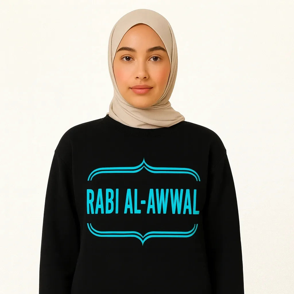 Woman wearing black Rabi Al-Awwal Islamic long sleeve shirt with teal design text, modest Muslim apparel on white background