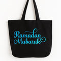 Black cotton Ramadan Mubarak tote bag with blue Islamic typography design, Muslim holiday reusable shopping bag, Eid gift tote