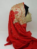 Elegant red hijab with gold beaded embroidery and rhinestone embellishments draped on mannequin head, luxury modest fashion scarf for weddings, Eid celebrations, and formal Islamic occasions.