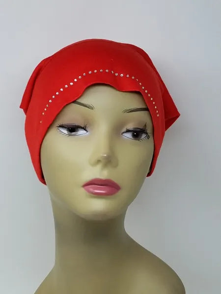 Bright red undercap hijab worn on mannequin, snug stretch inner cap with decorative edge detail, modest underscarf for secure fit under hijab, soft breathable fabric for daily wear, front and side view
