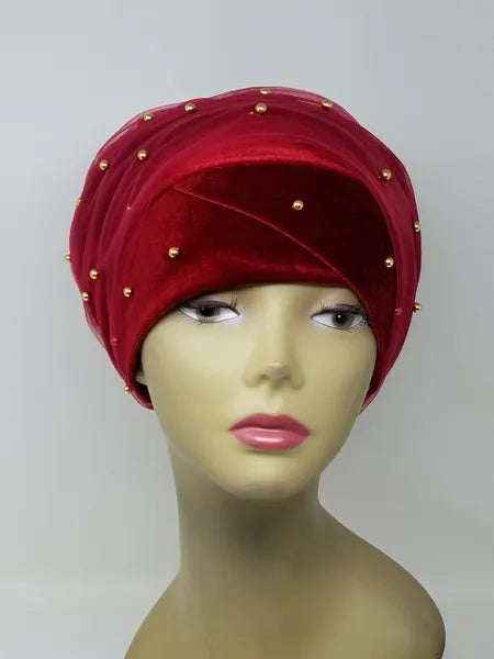 Elegant red velvet turban wrap with pearl bead embellishments styled on mannequin head, modest fashion velvet headwrap for women, soft pre wrapped hijab alternative for special occasions.