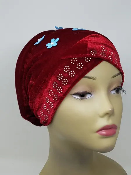 Red velvet hijab bun cap with pearl and rhinestone flower decoration and attached bun piece worn on mannequin head, modest under hijab cap designed to create bun shape for hijab styling from Affordable Hijab USA