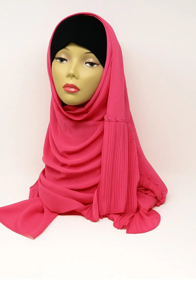 Rose pink chiffon hijab scarf made from soft lightweight flowing fabric, elegant modest Muslim headscarf styled on mannequin for breathable everyday hijab wear.