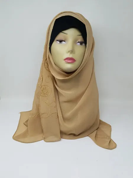 Tan chiffon hijab draped on mannequin, soft breathable scarf for modest wear, lightweight smooth fabric, flowy elegant texture, neutral tan hijab for everyday styling and special occasions