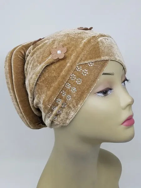 Tan velvet hijab bun cap with pearl and rhinestone flower decoration and attached bun piece worn on mannequin head, modest under hijab cap designed to create bun shape for hijab styling from Affordable Hijab USA