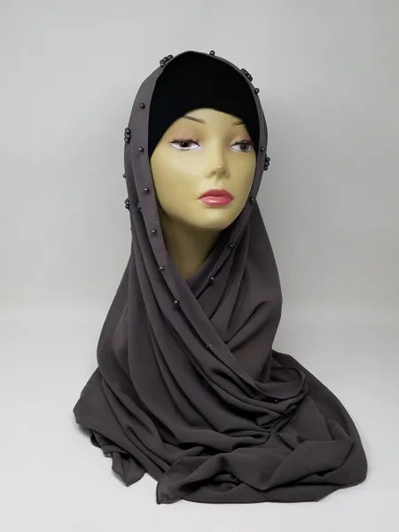 Taupe gray hijab scarf draped on mannequin, soft modest wrap with smooth drape, full coverage headscarf in neutral tone for everyday wear