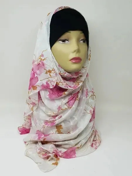 White floral georgette hijab draped on mannequin, lightweight breathable scarf with pink flower pattern, soft textured matte fabric, flowy elegant modest head covering for women, stylish hijab for everyday wear and special occasions