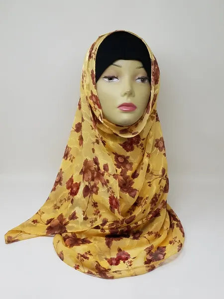Yellow floral georgette hijab draped on mannequin, lightweight breathable scarf with red flower pattern, soft textured matte fabric, flowy elegant modest head covering for women, stylish hijab for everyday wear and special occasions
