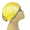 Yellow patterned sleep bonnet cap worn on mannequin head, breathable women hair protection bonnet for sleeping, modest overnight hair cover from Affordable Hijab USA